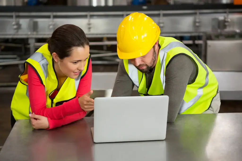 manual-workers-using-laptop-factory